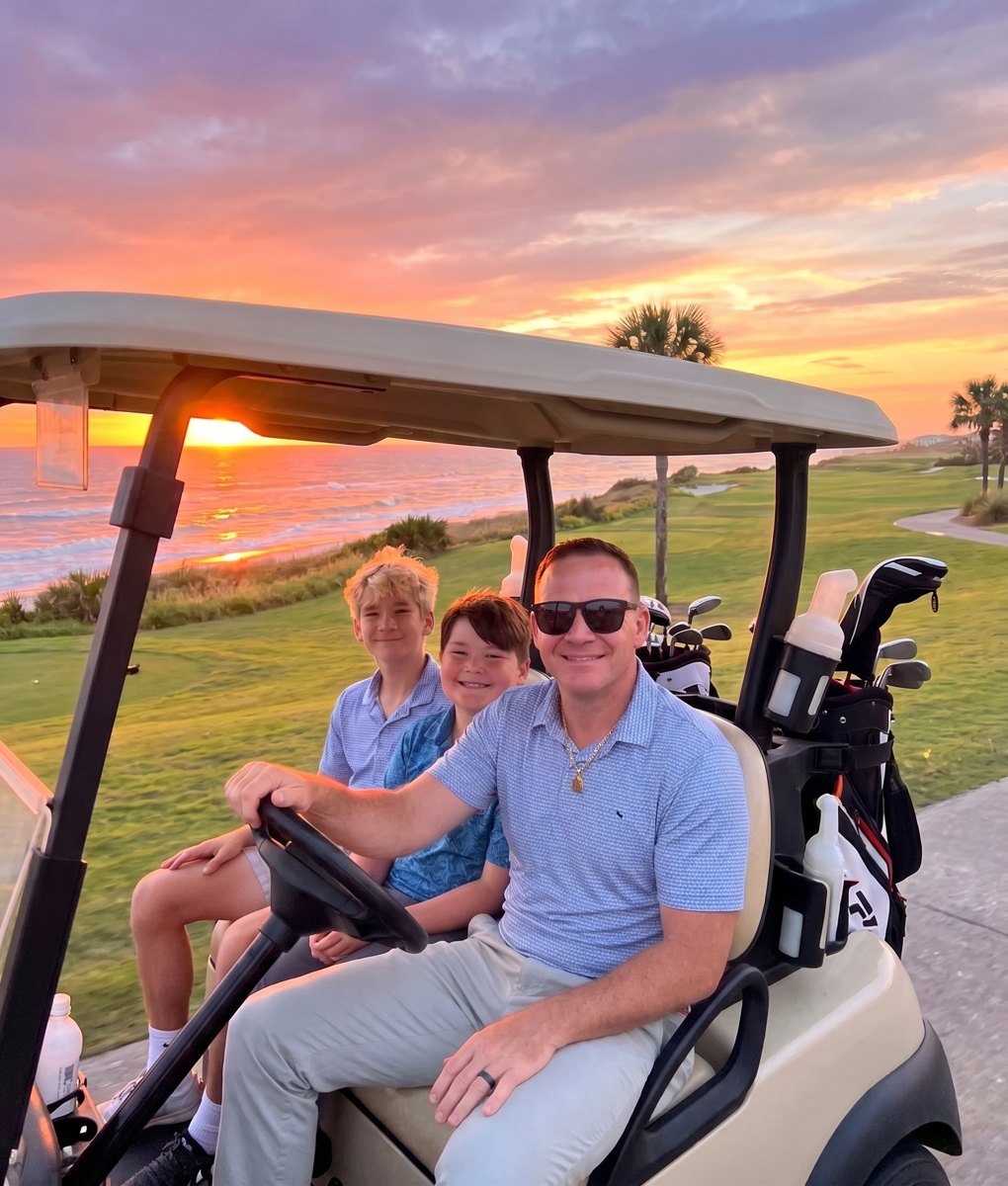 Peter and his sons in a golf cart at sunset